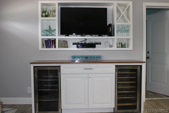 827 11th Avenue New Smyrna Beach, FL 32169 - Photo 17 of 21 a living room with flat screen tv and a fireplace