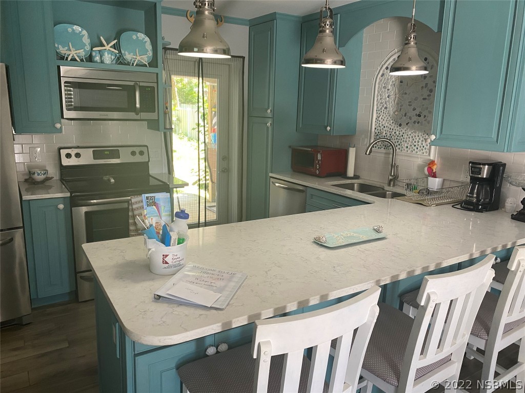 827 11th Avenue New Smyrna Beach, FL 32169 - Photo 2 of 21 a dining table with chairs and wooden floor