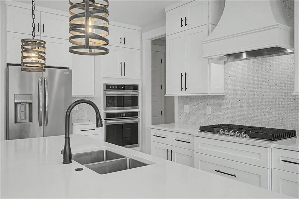 217 Laura Lake Road Marietta, GA 30066 - Photo 25 of 54 a kitchen with stainless steel appliances kitchen island a white stove top oven and cabinets