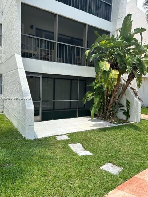 303 Racquet Club Road, Unit 106 Weston, FL 33326 - Photo 11 of 23 a view of a backyard with plants