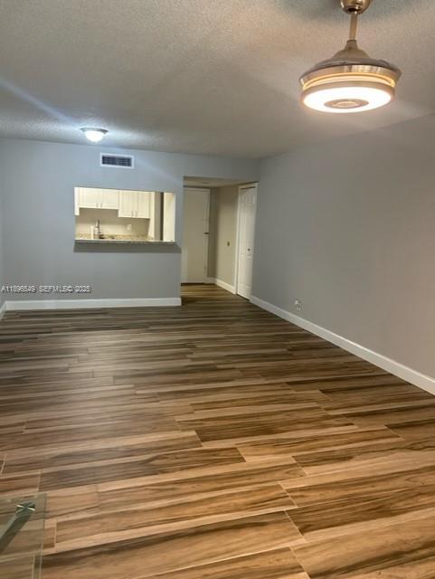 303 Racquet Club Road, Unit 106 Weston, FL 33326 - Photo 2 of 23 a view of empty room with wooden floor