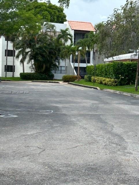 303 Racquet Club Road, Unit 106 Weston, FL 33326 - Photo 22 of 23 a view of a house with a yard and plants