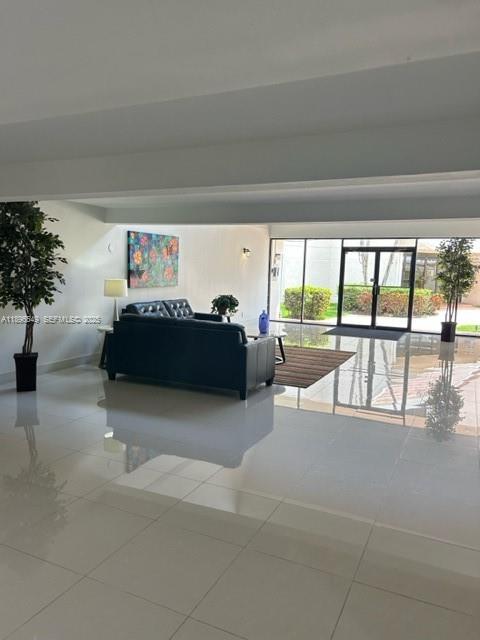 303 Racquet Club Road, Unit 106 Weston, FL 33326 - Photo 23 of 23 a living room with furniture and a large window