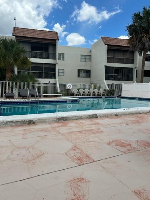 303 Racquet Club Road, Unit 106 Weston, FL 33326 - Photo 7 of 23 a front view of house with a yard