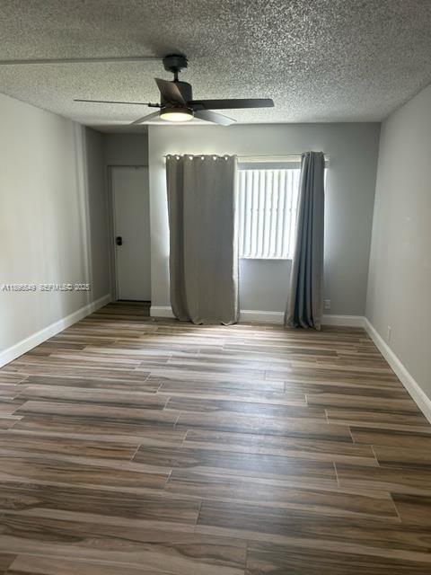 303 Racquet Club Road, Unit 106 Weston, FL 33326 - Photo 8 of 23 a view of a livingroom with wooden floor and window