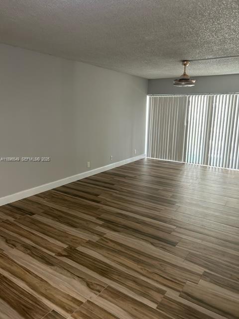 303 Racquet Club Road, Unit 106 Weston, FL 33326 - Photo 10 of 23 wooden floor in a empty room