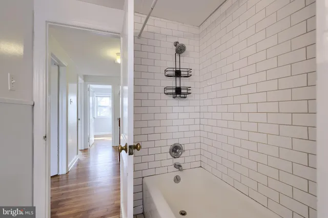 a bathroom with a bathtub and shower