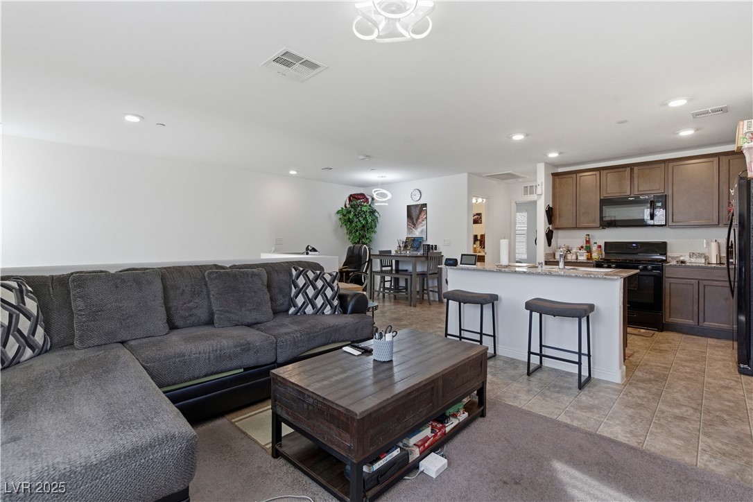 4648 Woolcomber Street Las Vegas, NV 89115 - Photo 16 of 41 Living area with recessed lighting and light tile patterned flooring