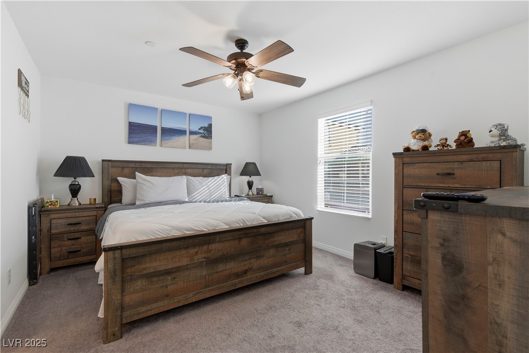 4648 Woolcomber Street Las Vegas, NV 89115 - Photo 18 of 41 Carpeted bedroom featuring a ceiling fan and baseboards
