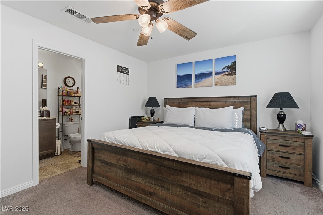 4648 Woolcomber Street Las Vegas, NV 89115 - Photo 19 of 41 Bedroom featuring carpet floors, ensuite bathroom, and ceiling fan