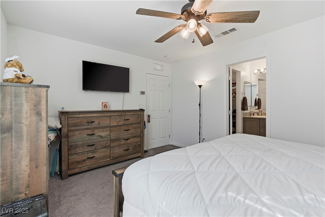 4648 Woolcomber Street Las Vegas, NV 89115 - Photo 20 of 41 Bedroom featuring carpet flooring, ceiling fan, and ensuite bathroom