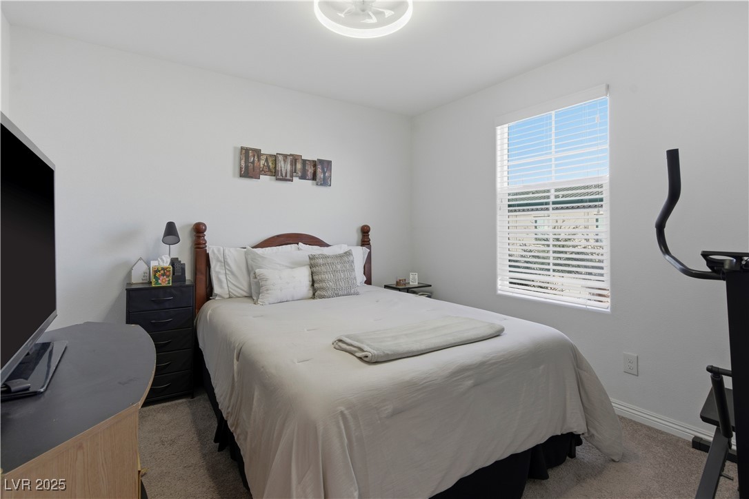 4648 Woolcomber Street Las Vegas, NV 89115 - Photo 24 of 41 Bedroom with light carpet and baseboards
