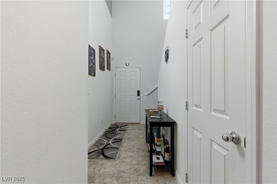4648 Woolcomber Street Las Vegas, NV 89115 - Photo 3 of 41 Hall with baseboards and light tile patterned floors