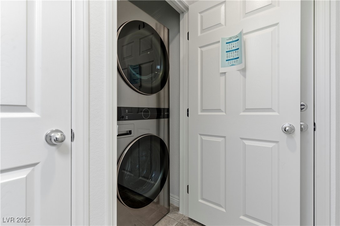 4648 Woolcomber Street Las Vegas, NV 89115 - Photo 29 of 41 Washroom featuring tile patterned floors and estacked washer and dryer