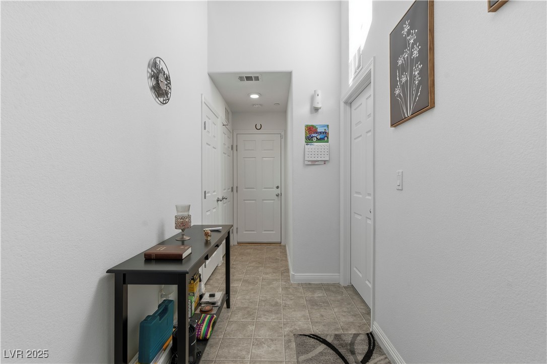 4648 Woolcomber Street Las Vegas, NV 89115 - Photo 4 of 41 Corridor featuring baseboards and light tile patterned floors