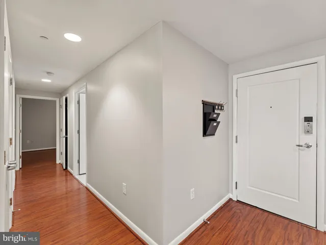 a view of hallway with wooden floor