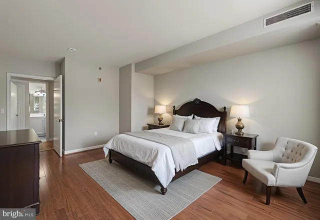 a bedroom with a bed and a chair