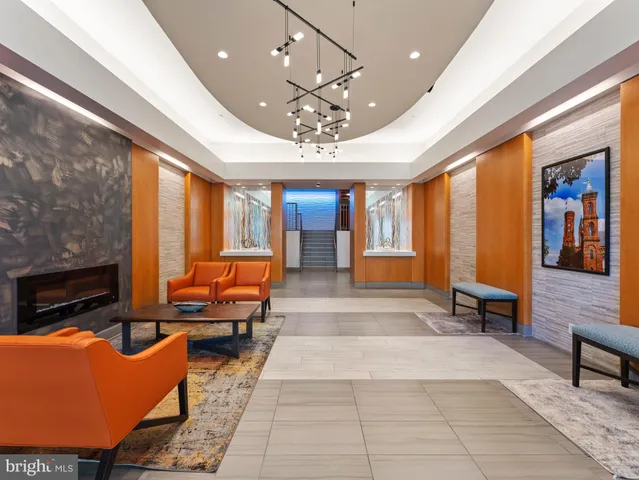 a lobby with furniture and large windows