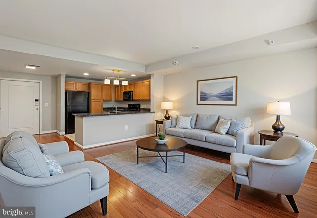 a living room with furniture and a view of kitchen