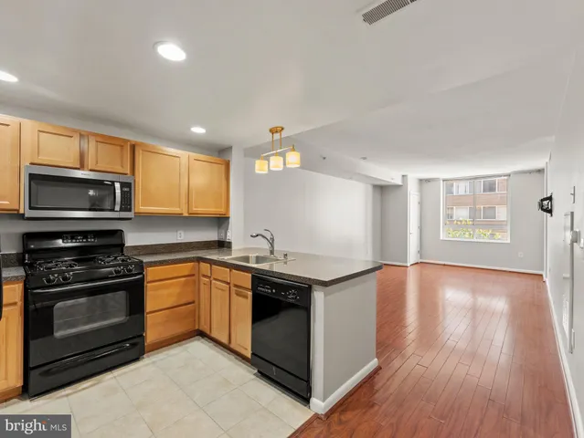 a kitchen with granite countertop a stove top oven and sink