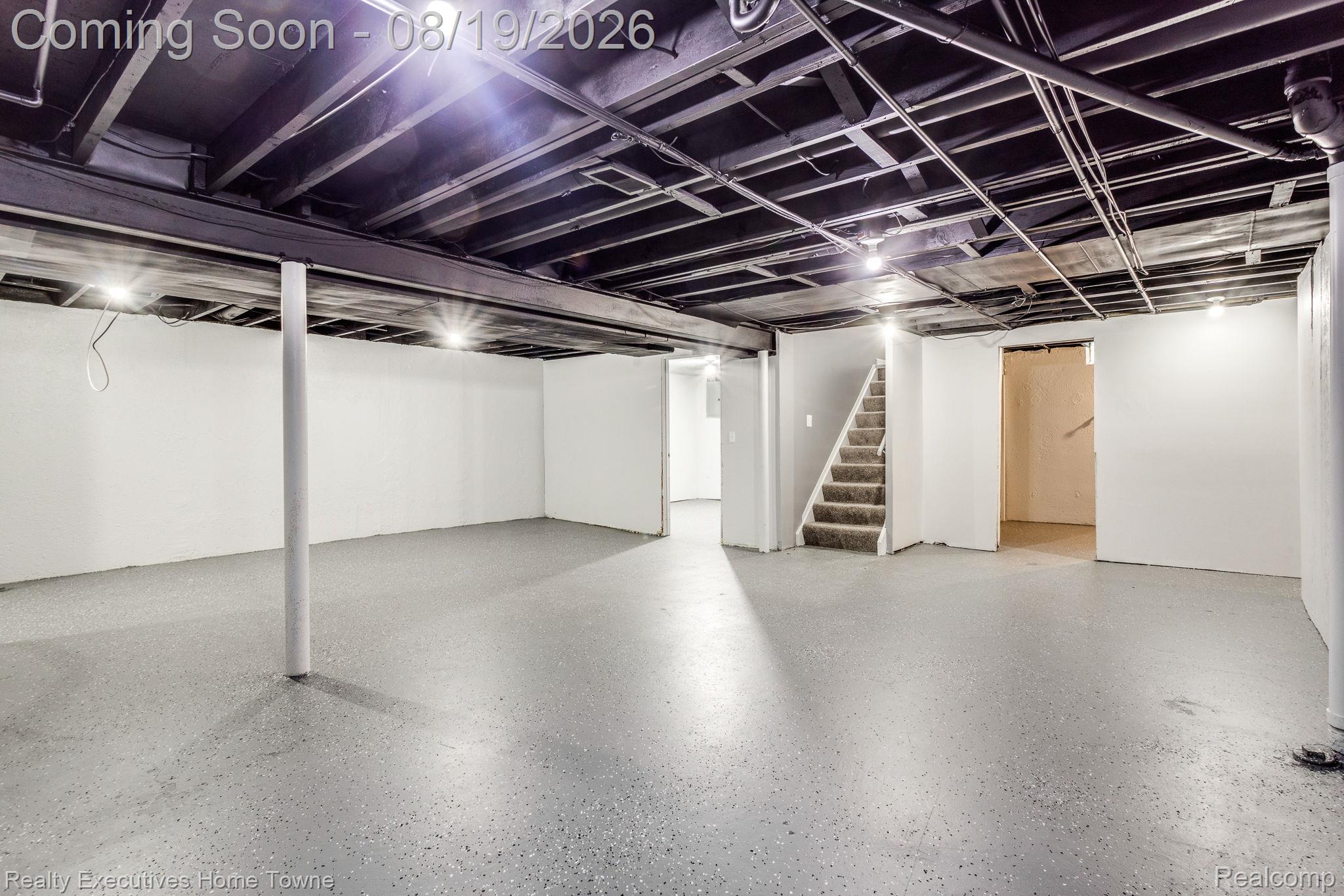 2448 Oakcrest Road Sterling Heights, MI 48310 - Photo 21 of 31 Expansive open space with concrete flooring, white walls, exposed black ceiling joists, and recessed lighting