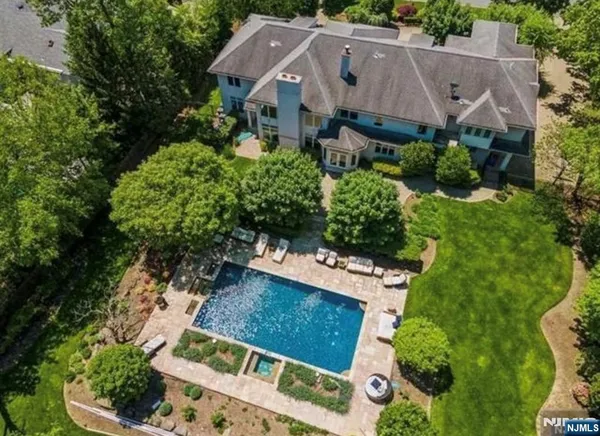 an aerial view of a house with garden space and street view