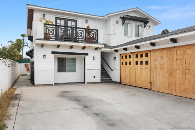 a view of a white house with many windows