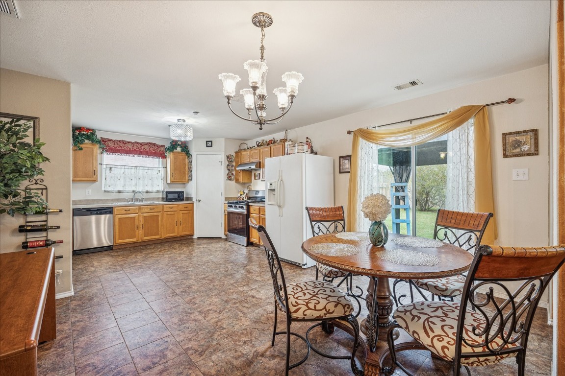 12811 Rio Lindo Street Rosharon, TX 77583 - Photo 4 of 13 a view of a dining room with furniture and wooden floor