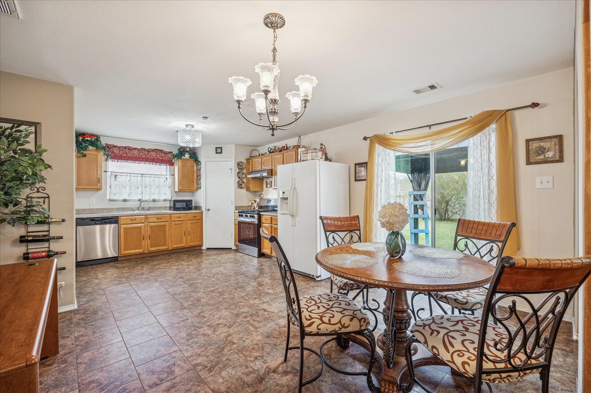 12811 Rio Lindo Street Rosharon, TX 77583 - Photo 4 of 13 a view of a dining room with furniture and chandelier