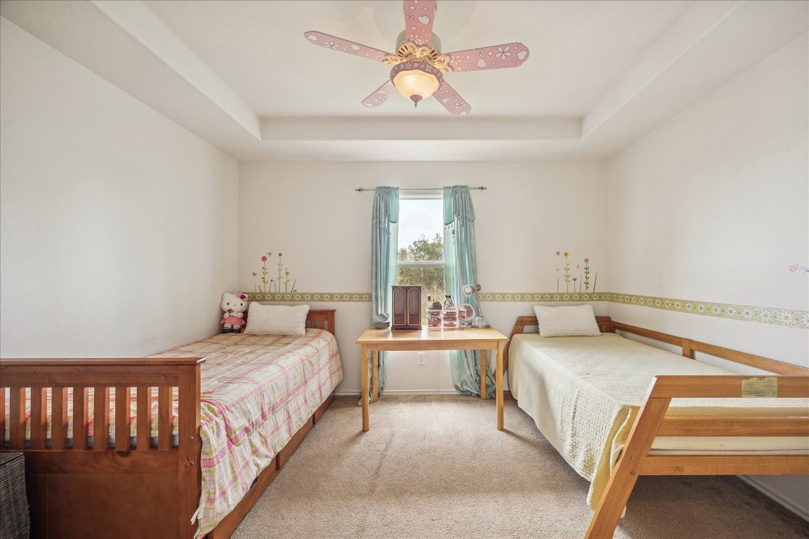 12811 Rio Lindo Street Rosharon, TX 77583 - Photo 10 of 13 a bedroom with a bed and a chandelier