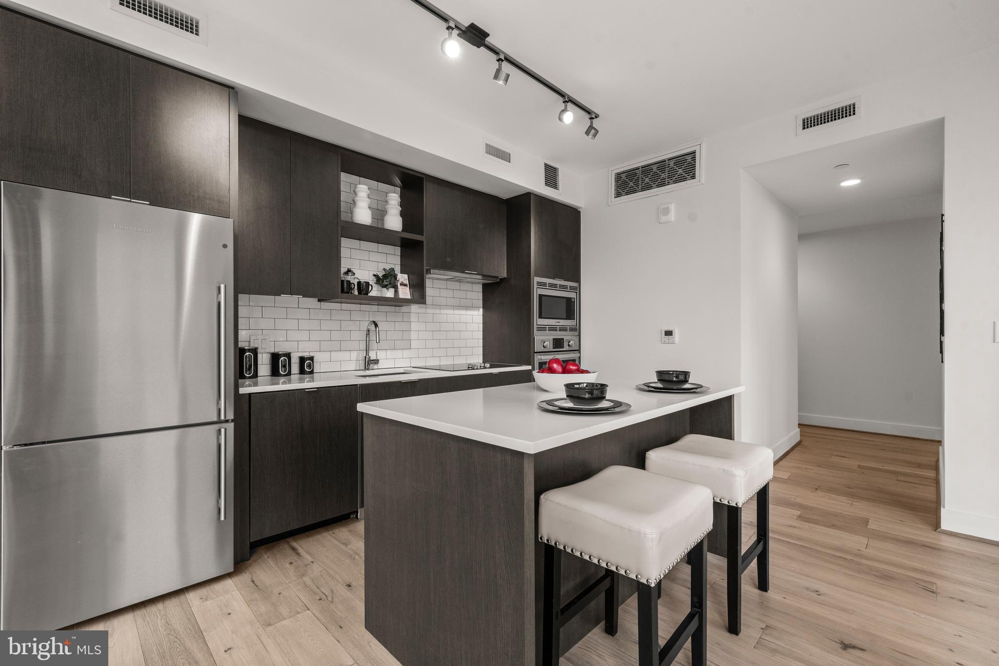 1300 4th Street Southeast, Unit 312 Washington, DC 20003 - Photo 11 of 39 a kitchen with refrigerator and cabinets