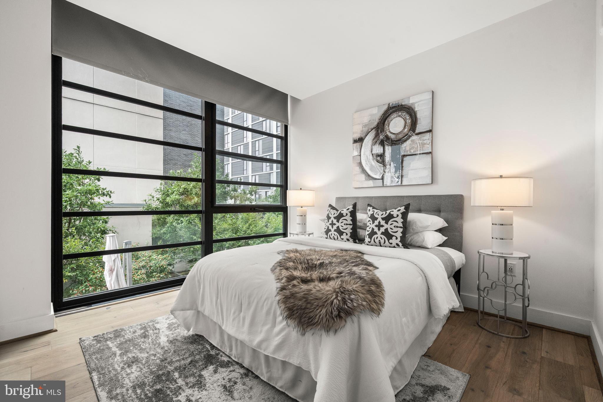 1300 4th Street Southeast, Unit 312 Washington, DC 20003 - Photo 12 of 39 a bedroom with a bed and a large window