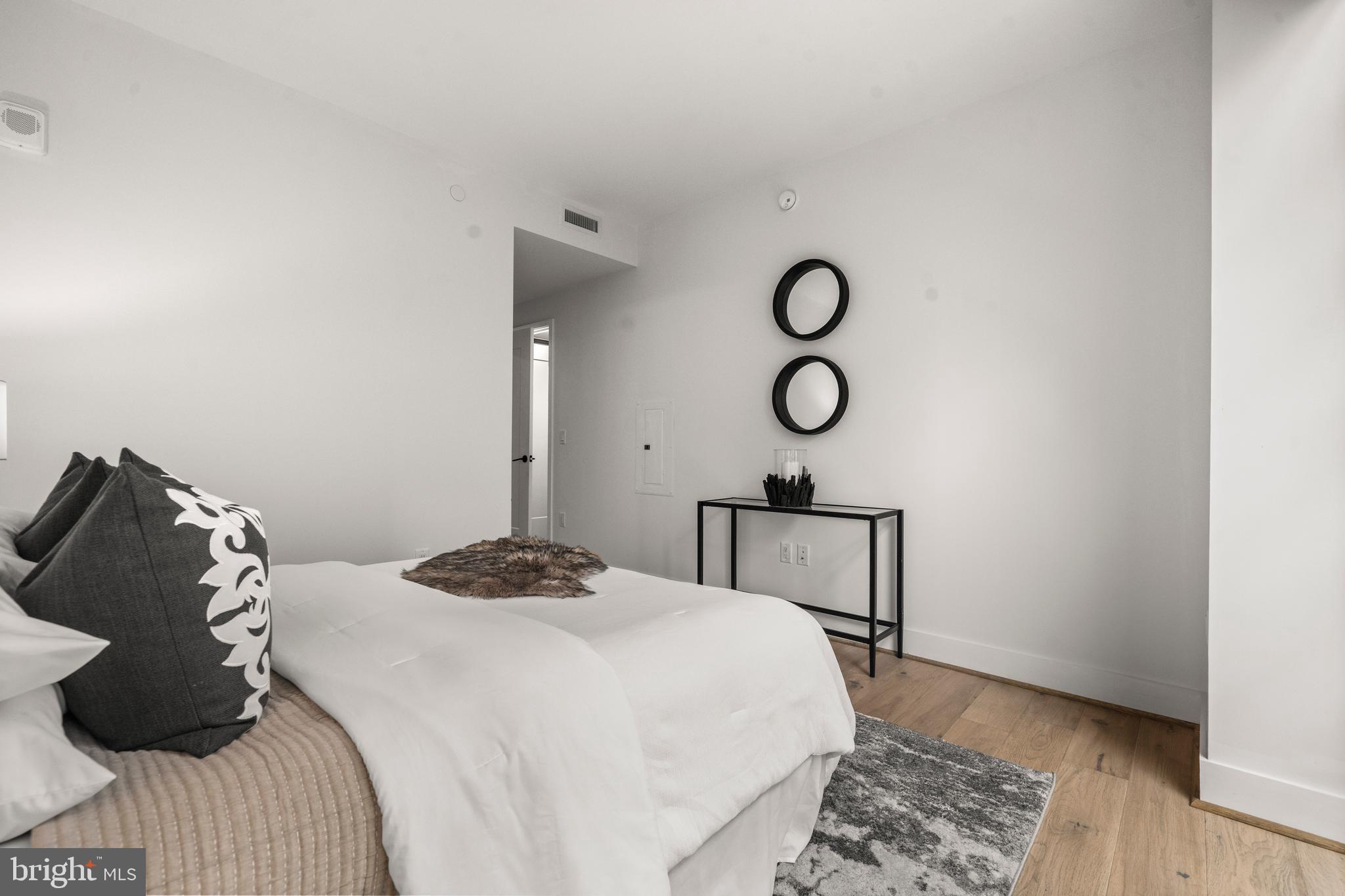 1300 4th Street Southeast, Unit 312 Washington, DC 20003 - Photo 13 of 39 a bedroom with a bed and cabinets