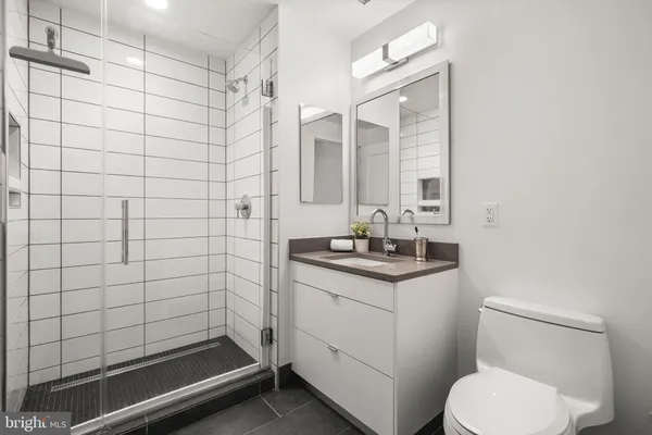 a bathroom with a sink toilet and shower