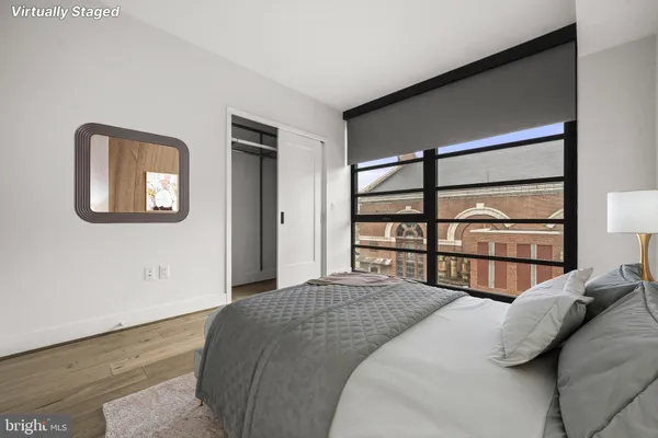 a bedroom with a bed and a window