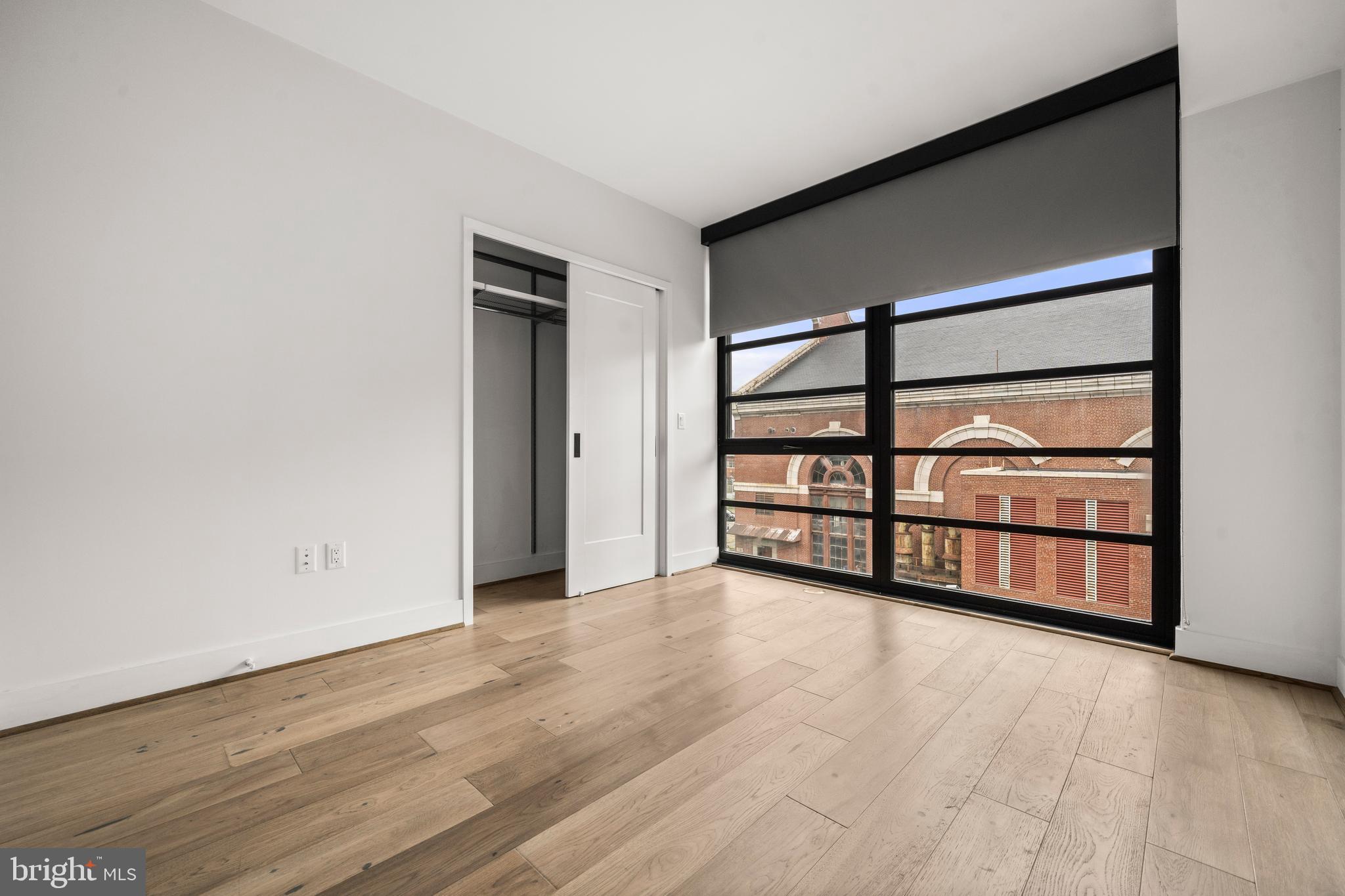 1300 4th Street Southeast, Unit 312 Washington, DC 20003 - Photo 19 of 39 an empty room with wooden floor and windows