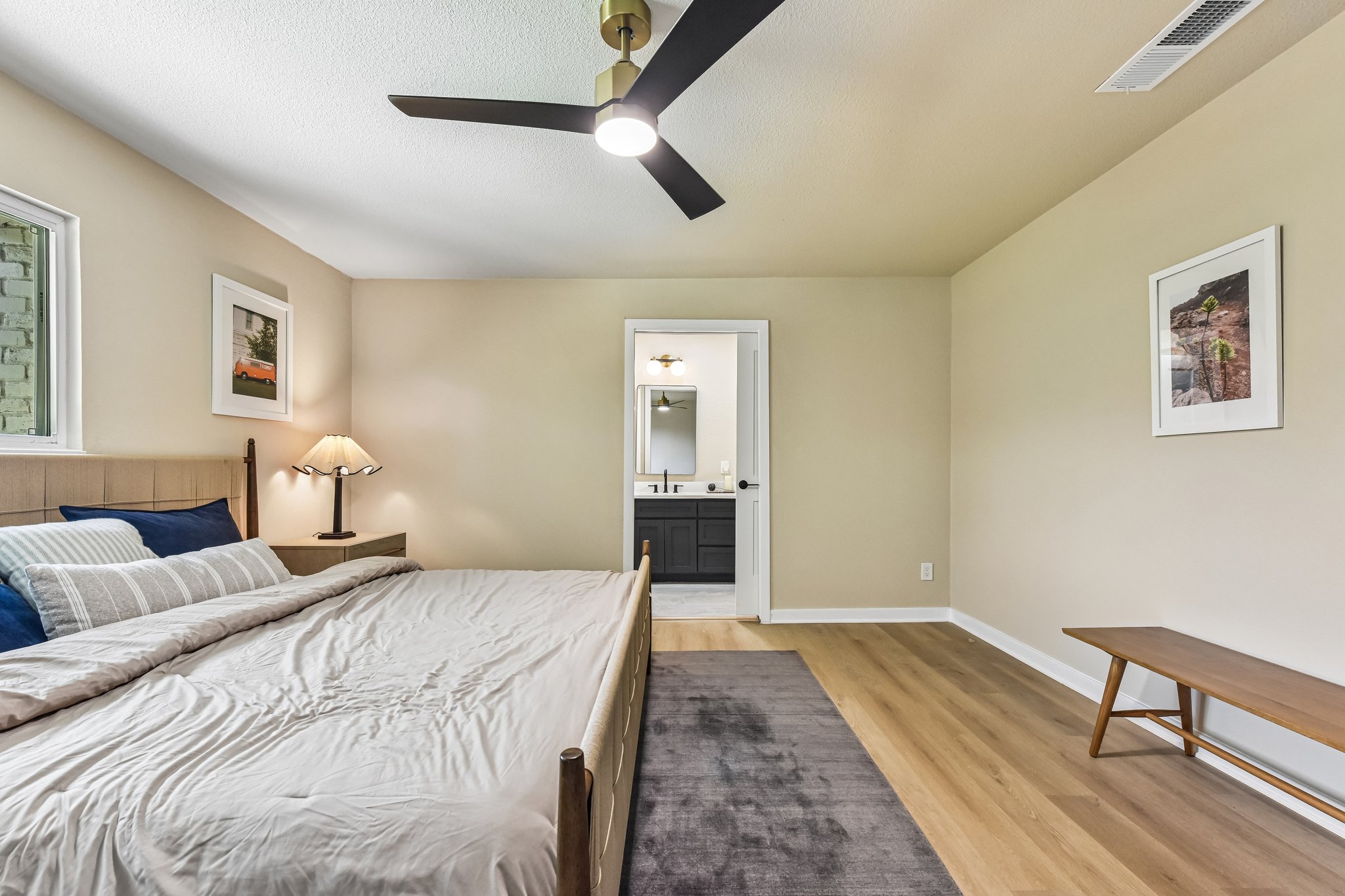7523 Glenhill Road Austin, TX 78752 - Photo 18 of 38 A quiet bedroom retreat features a modern ceiling fan and direct access to a private bathroom.