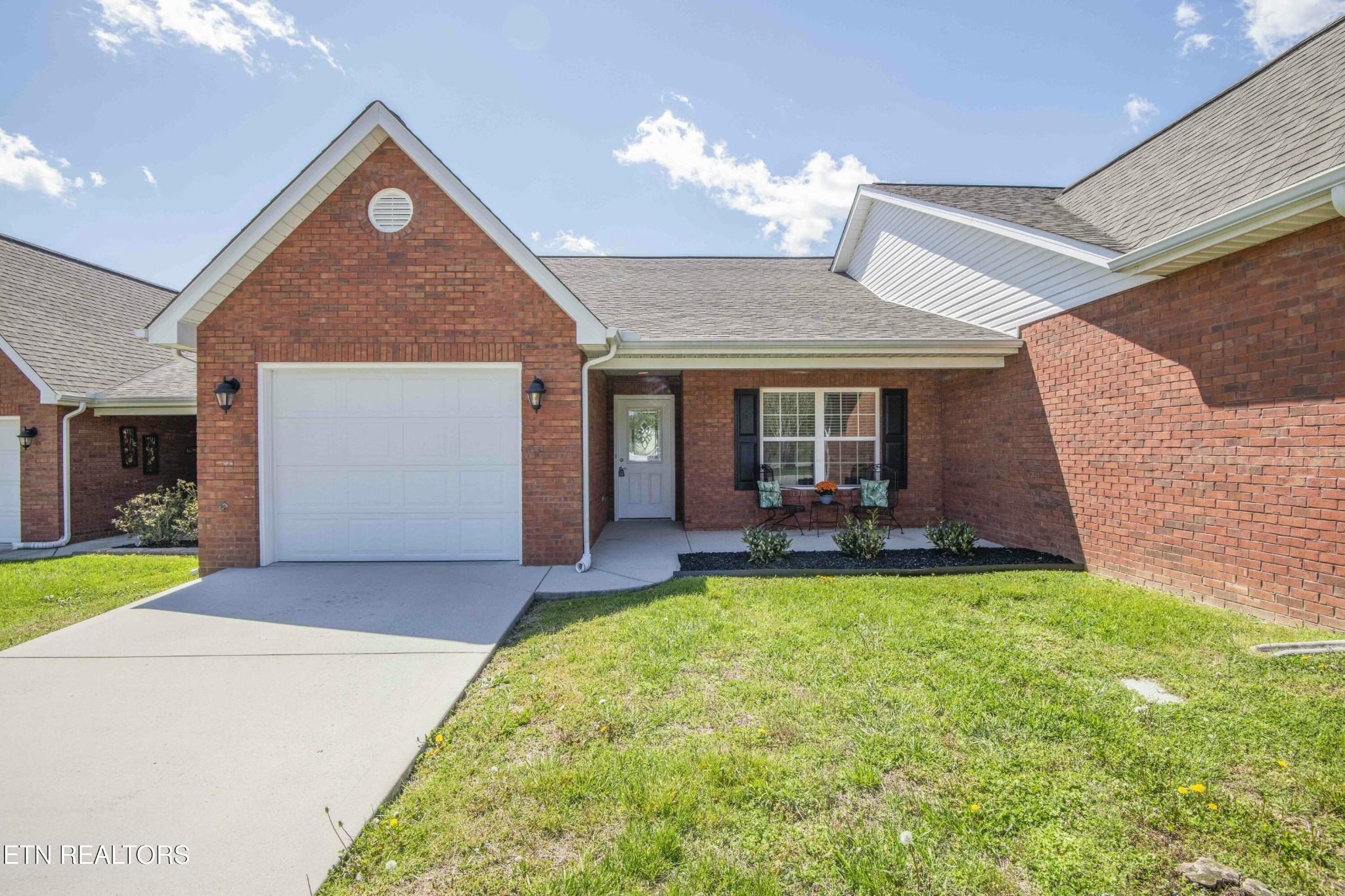 a view of a house with a yard and porch