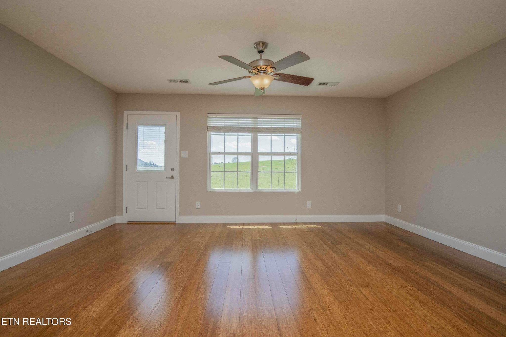 337 Angus Crossing Corryton, TN 37721 - Photo 11 of 36 a view of an empty room with wooden floor and a window