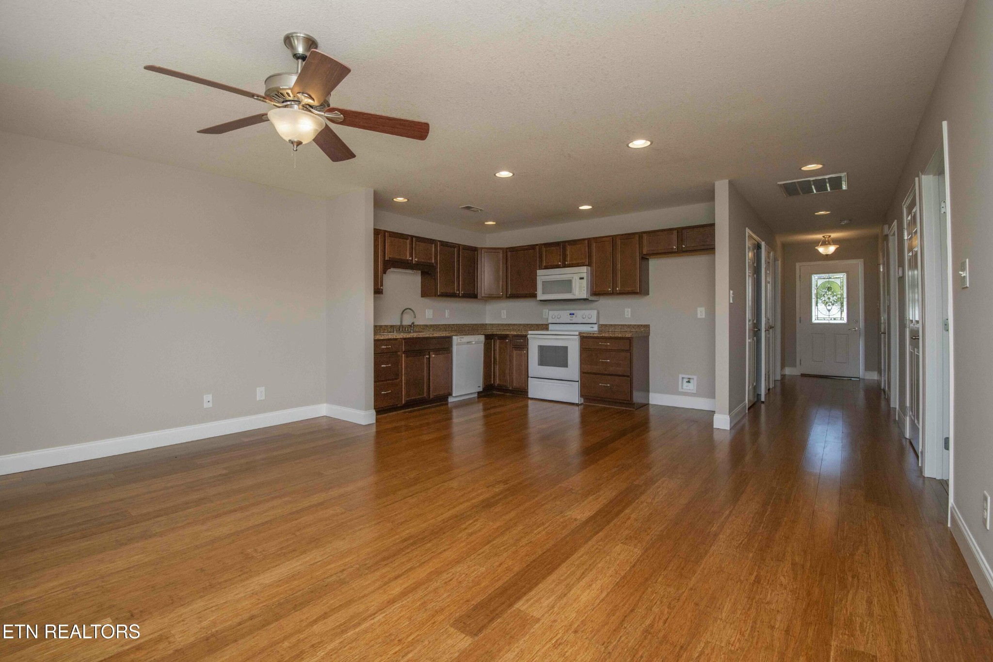 337 Angus Crossing Corryton, TN 37721 - Photo 13 of 36 a view of a big room with wooden floor and a kitchen