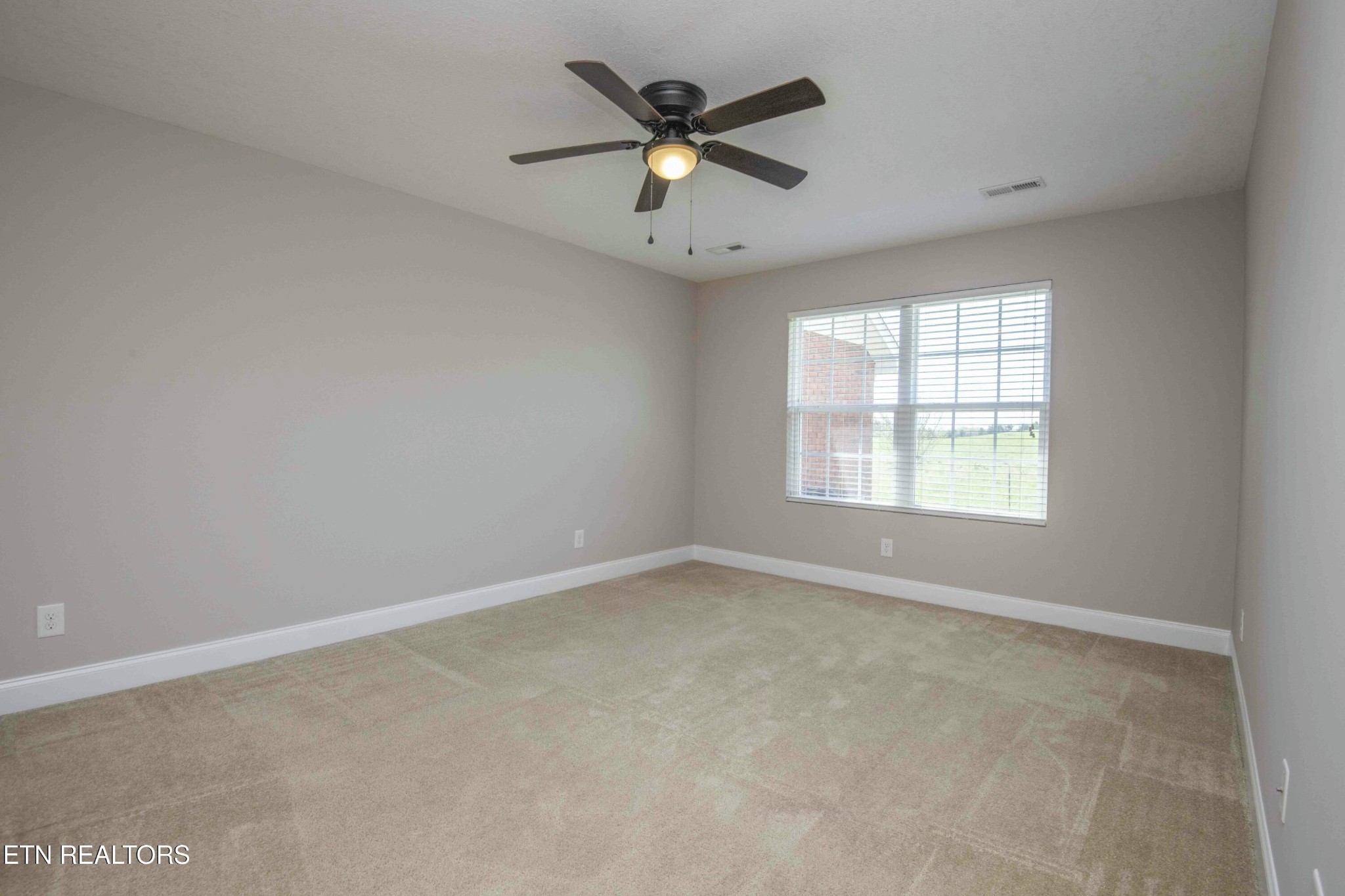 337 Angus Crossing Corryton, TN 37721 - Photo 21 of 36 an empty room with a window and a ceiling fan