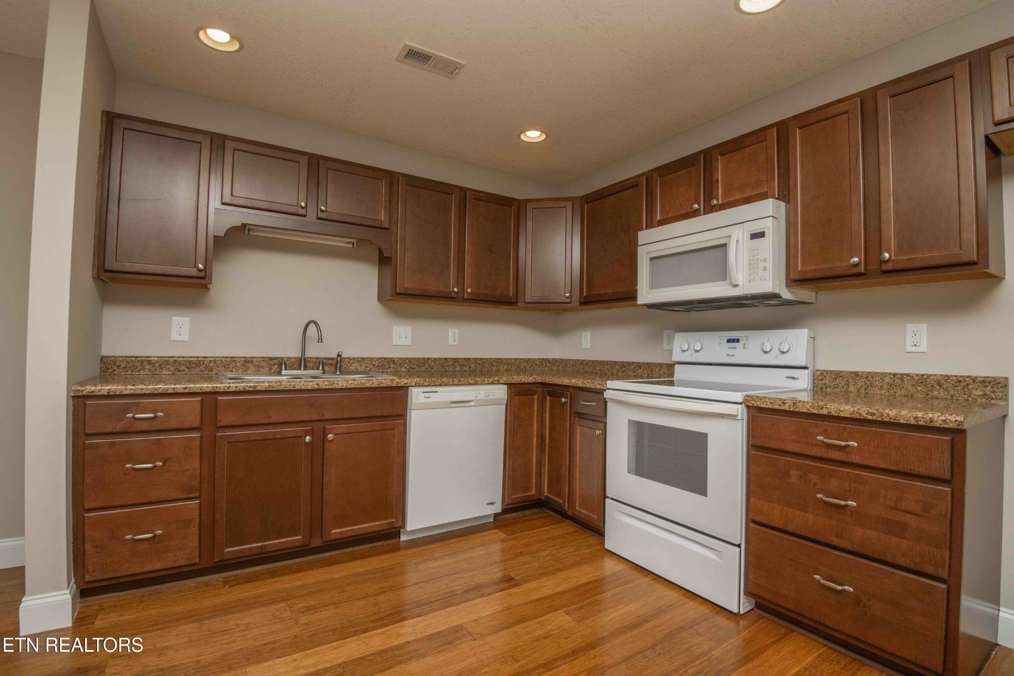 337 Angus Crossing Corryton, TN 37721 - Photo 6 of 36 a kitchen with granite countertop wooden cabinets and stainless steel appliances