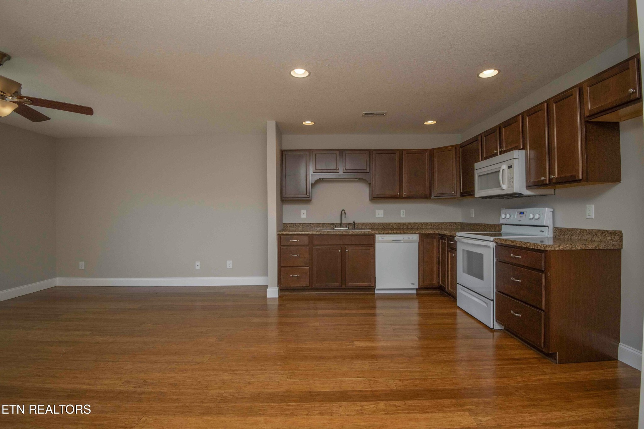 337 Angus Crossing Corryton, TN 37721 - Photo 7 of 36 a large kitchen with stainless steel appliances granite countertop a stove a sink and a microwave