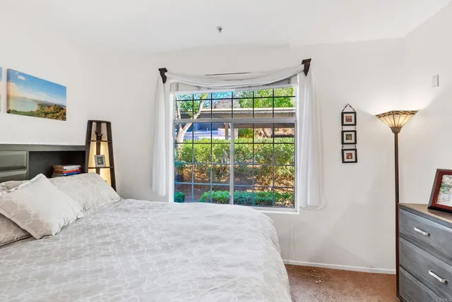 a view of a workspace with wooden floor and a window