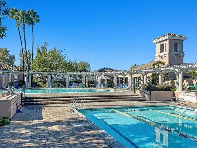 a room with gym equipment and large windows
