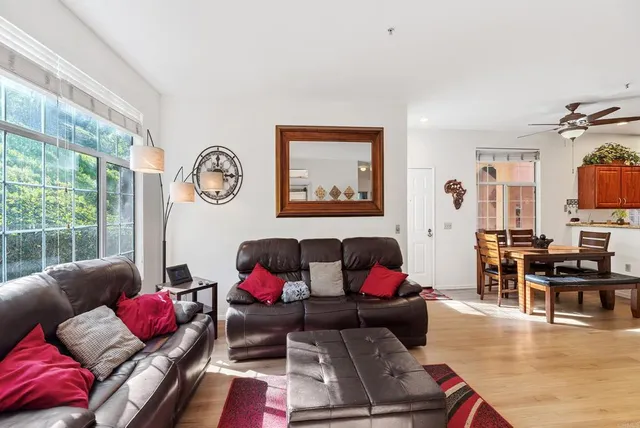 a kitchen with stainless steel appliances granite countertop a refrigerator a stove and a sink with wooden cabinets