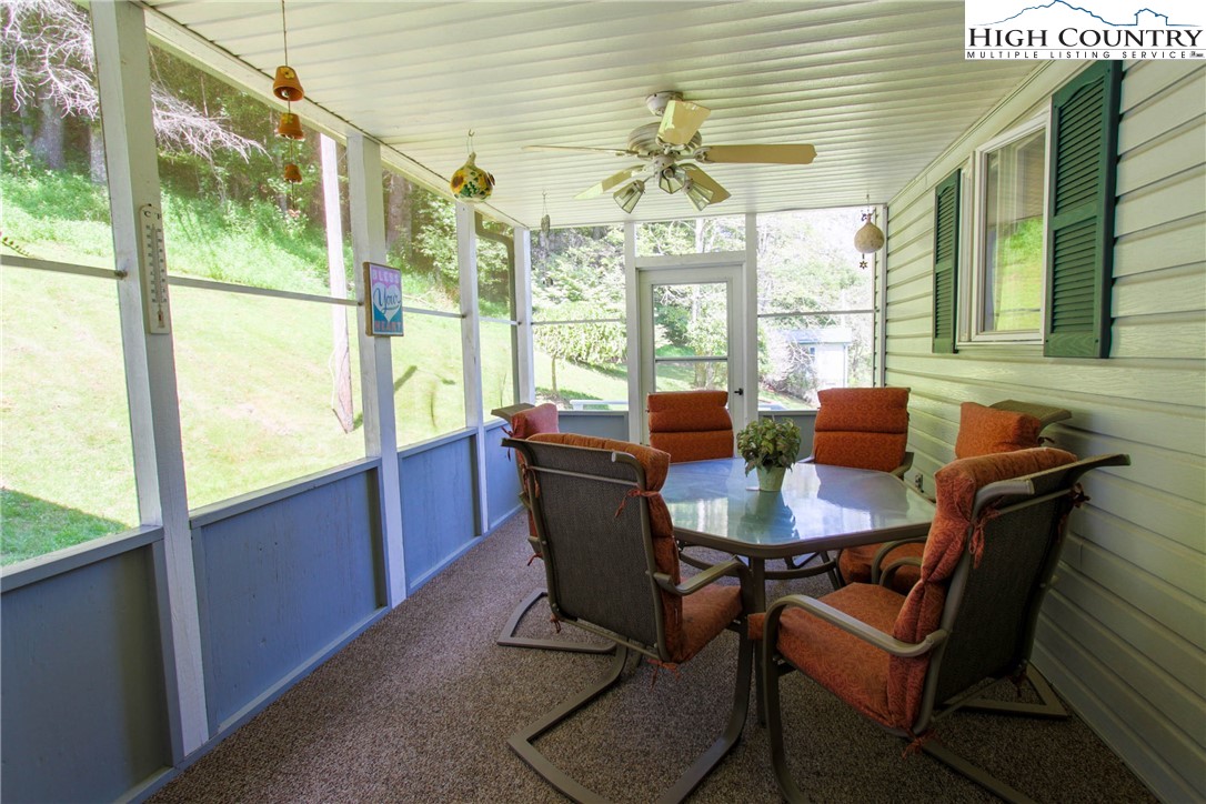 581 North Fork New River Road Lansing, NC 28643 - Photo 26 of 44 a view of a dining room with furniture large windows and wooden floor