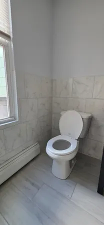 a white toilet sitting next to a bathroom sink