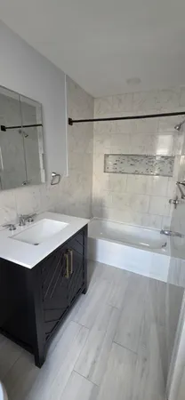 a bathroom with a sink a mirror and a shower