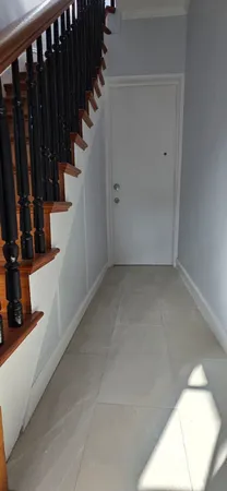 a view of a hallway with stairs